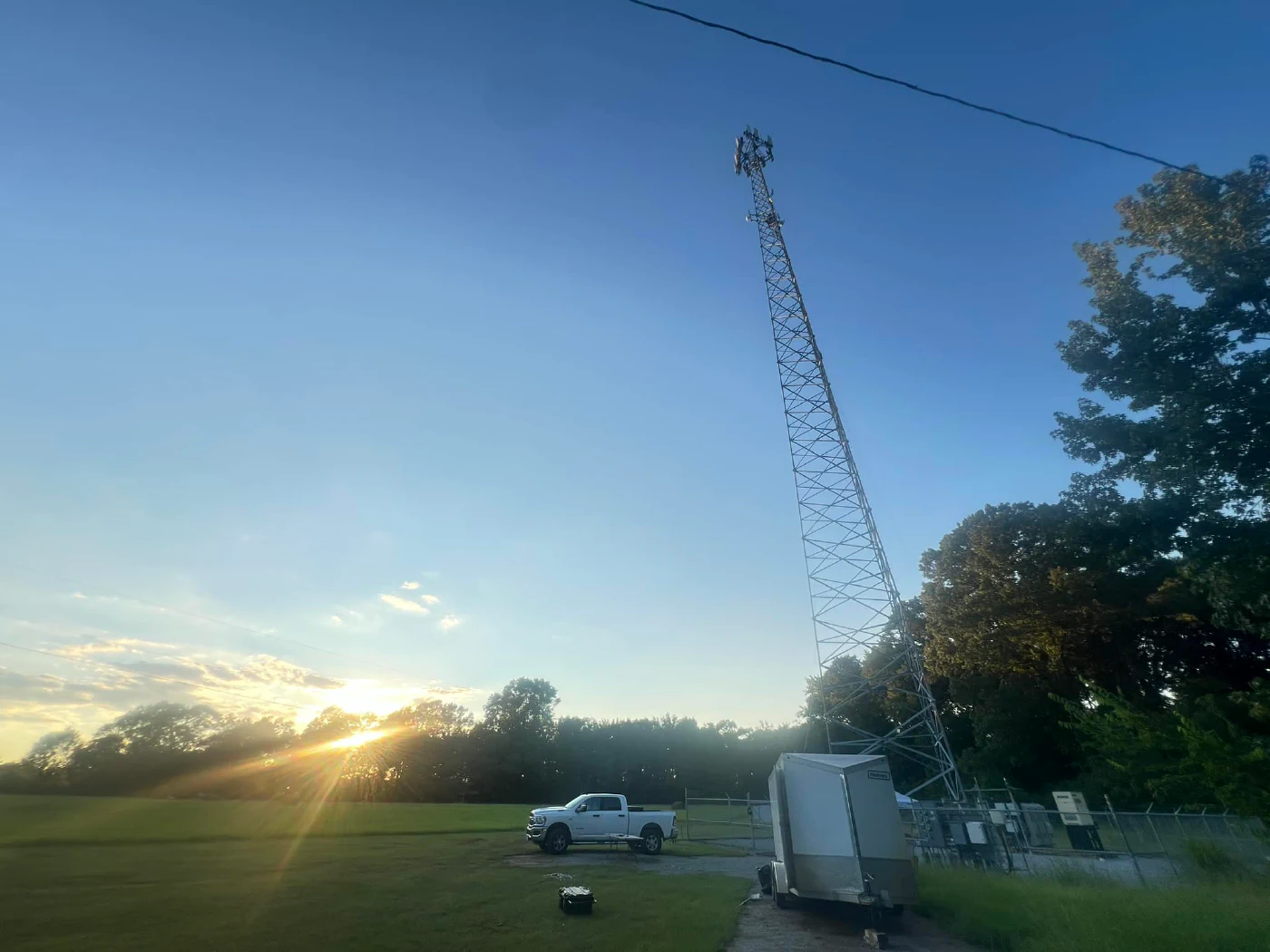 Alabama Lightwave tower at sunrise, Vertical Axis crew truck and trailer on site