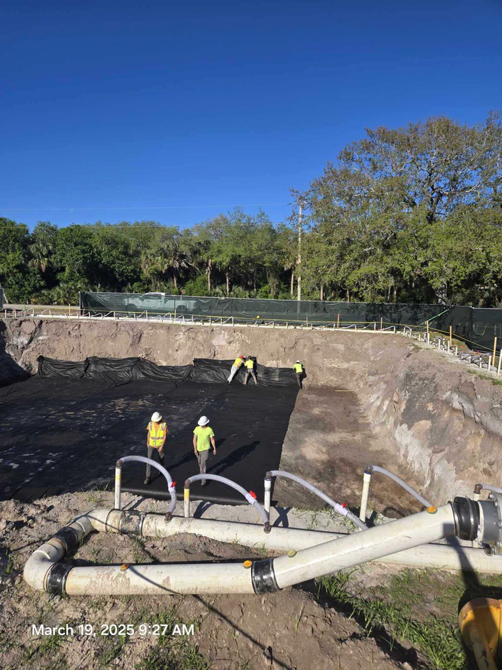 Vertical Axis crew in the excavated tower foundation pit with dewatering piping running on a Streamline Internet site in Hendry County, Florida