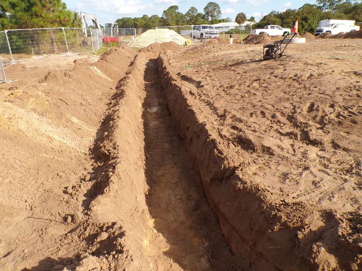 Ground-ring and conduit trench on a Streamline Internet tower site in Hendry County, Florida, dug alongside the compound perimeter