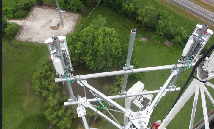 Climber performing a condition inspection on a communications tower