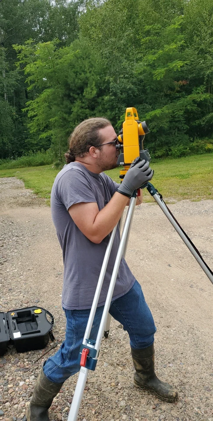 Crew rigging a load cell to measure guy-wire tension