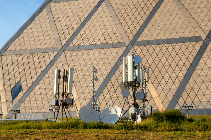 Concealed sector antenna arrays mounted against a large geometric facade, an example of the unusual siting and camouflage constraints that drive edge-case RF design work